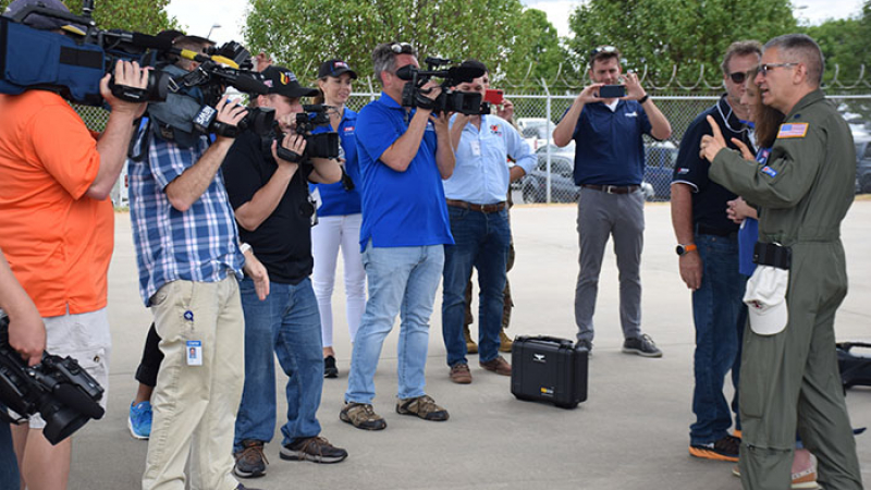 Members of the media gather round USAF pilot Lt.Col Jeff Ragusa in 
Charlotte, N. Car., as he describes how the plane flies in and out of a hurricane. A critical part of the Awareness Tours is the participation of the media. The videos and interviews are seen on broadcast and social media, reaching as many people as possible to raise awareness.  May 9, 2019.
