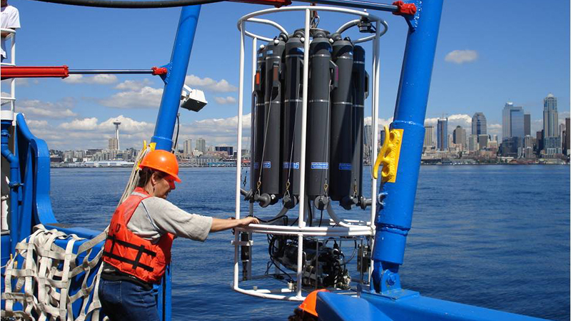 University of Washington oceanographer Jan Newton uses an oceanography instrument to measure conductivity, temperature and depth in Puget Sound.