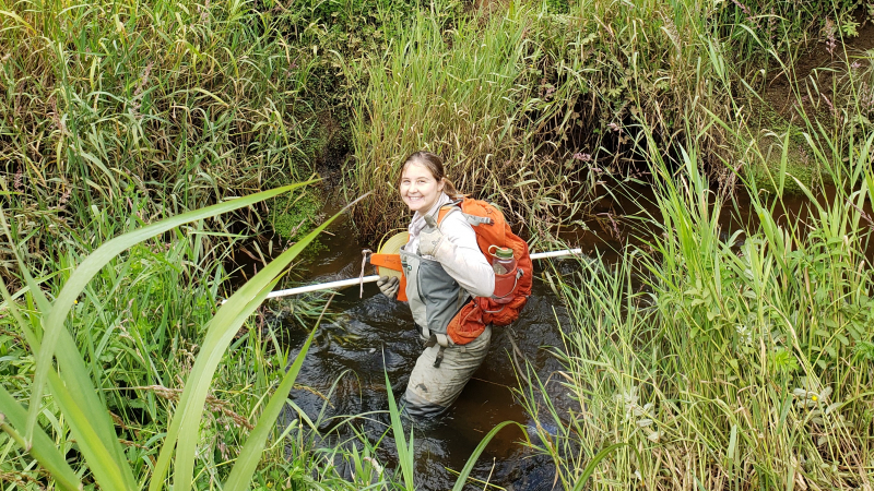 Madison Bowe, a 2018 NOAA Hollings scholar, crosses a channel in Winchester Marsh, a sentinel site marsh in South Slough National Estuarine Reserve, Oregon.