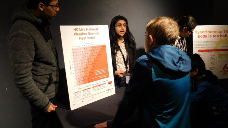 Teens Aaron Rivera-Marquez and Tanmayee Vegesna discuss NOAA’s Heat Index and how heat can affect you at a family day event at the Museum of Science and Industry in March 2018.