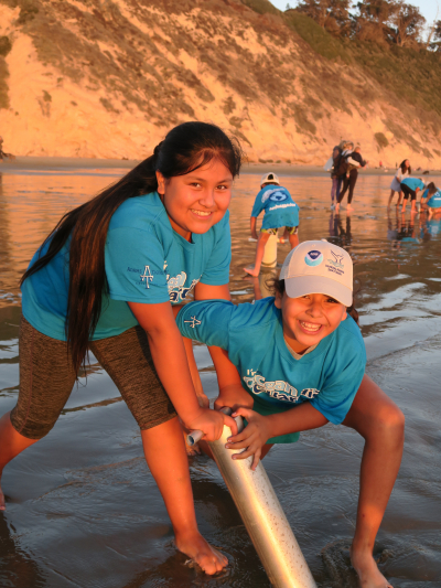 Two Ocean Guardian Ambassadors from Adams Elementary School participate in LiMPETS sandy beach monitoring in the search for the small Pacific mole crab (Emerita analoga) at Hendry's Beach. Adams Elementary School is a Title I school in Santa Barbara, California that is in its fifth year as a NOAA Ocean Guardian School. During the 2018-2019 school year, the Adams Ocean Guardians (third through sixth grade students) had an opportunity to have some first-hand experiences with the ocean before learning about