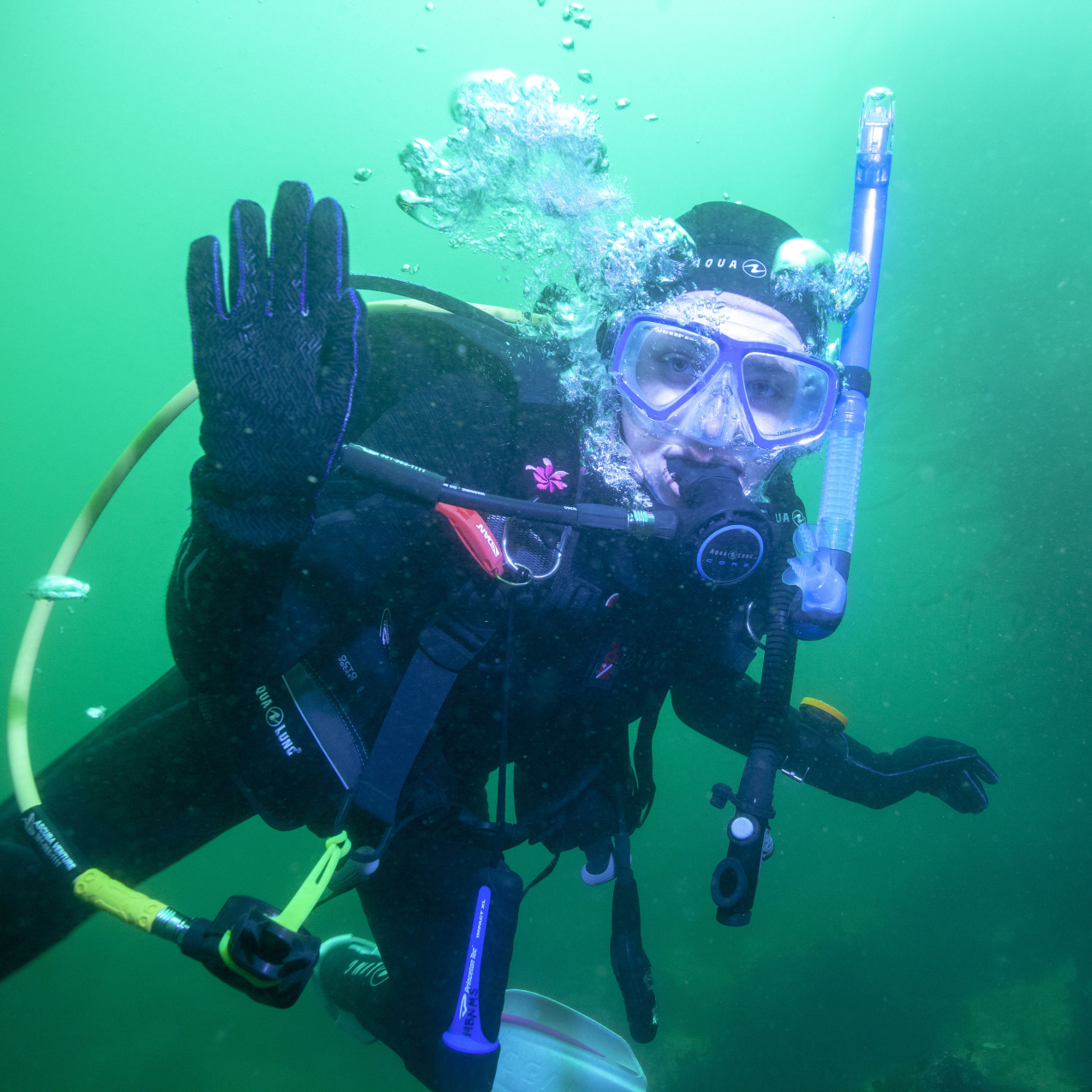 Hannah Brady, a 2018 NOAA Hollings scholar, waves to the camera after having finished taking pre-construction photos of the Monterey Bay Aquarium pipe for her summer internship.