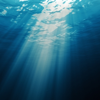 Photo showing Light underwater abstract blue ocean background.
