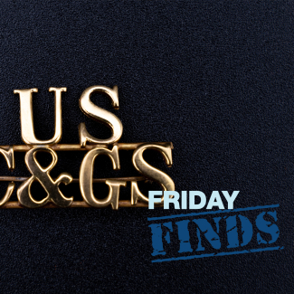 Photo of a gold pin with the letters "US" above "C&GS" in a serif font. The pin rests on a black background. The NOAA logo is in the upper left corner and the words "Friday Finds" are in the lower right corner.