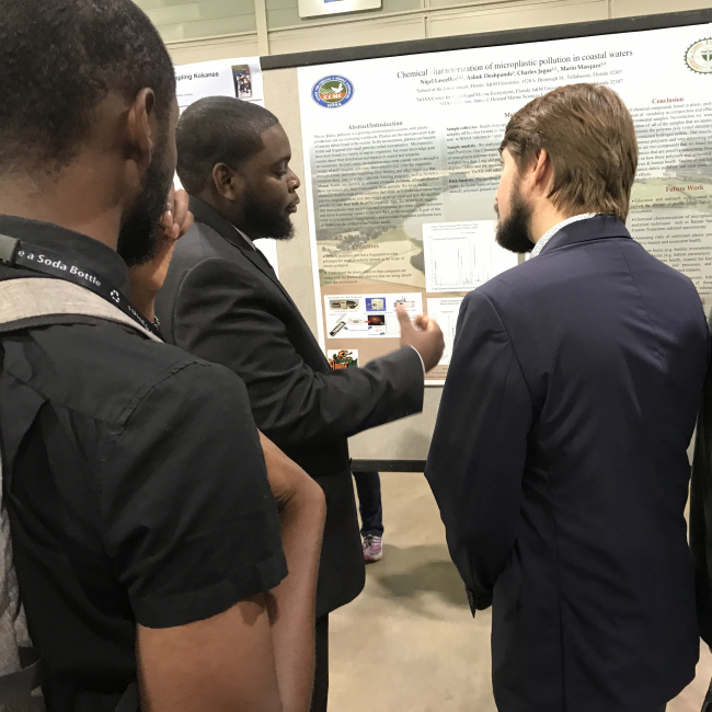Nigel Lascelles, a graduate student supported by NOAA's Educational Partnership Program with Minority Serving Institutions (EPP/MSI) Cooperative Science Centers (CSCs), discusses his research with colleagues at the ASLO Aquatic Sciences Meeting in Puerto Rico in January 2019.