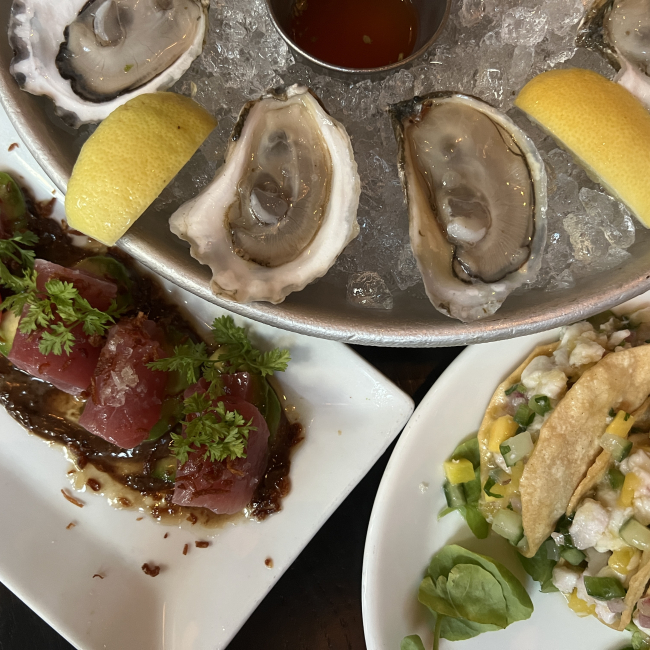 A seafood platter of tuna crudo, halibut-ceviche tacos, and Eastern oysters. 