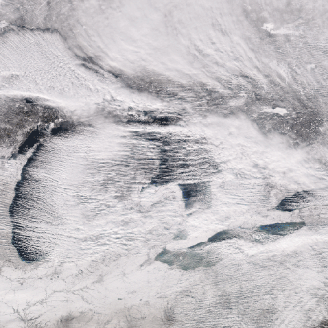 Lake effect snow bands moving across the Great Lakes, seen from the Suomi NPP polar-orbiting satellite on December 25, 2017. 