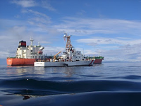 Two Coast Guard ships, at-sea boarding