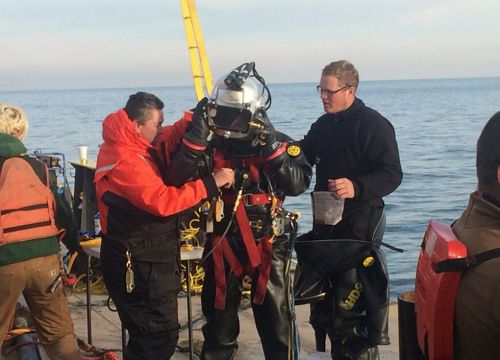A diver, wearing a positive pressure dive suit, is inspected by his coworkers prior to conducting dive operations for the Argo response in Lake Erie, Nov. 24, 2015.