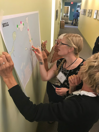 Teachers look at a map of Hull, Massachusetts, to determine the town's climate vulnerabilities.