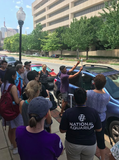 Vivek Shandas, professor of urban studies and planning at Portland State University, demonstrates how to install a temperature sensor on a car for the 2018 urban heat island mapping campaign.