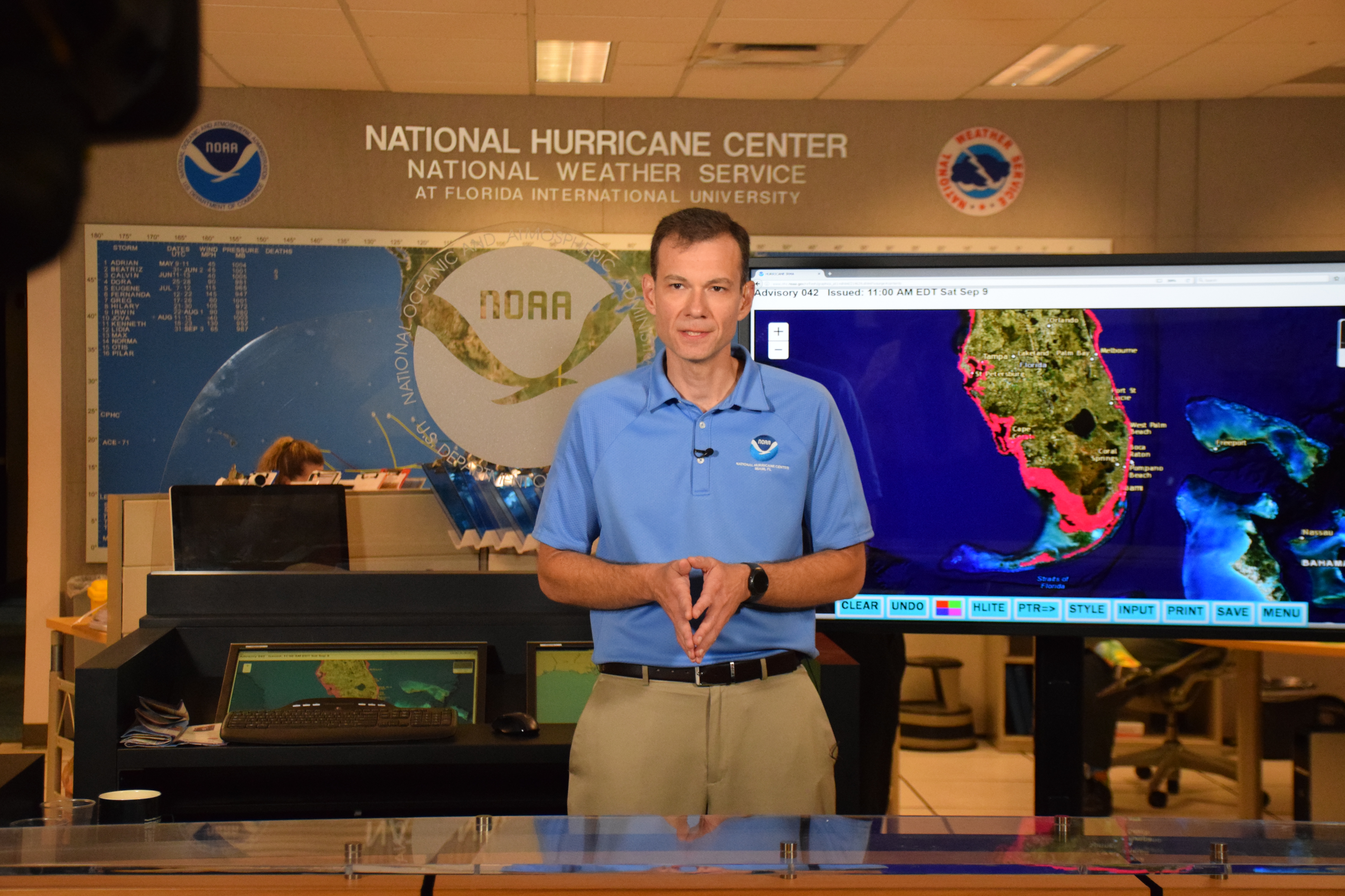 Jamie R. Rhome with NOAA’s National Hurricane Center has been awarded the prestigious 2019 Service to America medal for his pioneering work in forecasting and warning the public about the deadly and destructive inundation of water associated with a hurricane’s storm surge. Here Jamie is shown giving a television interview about Hurricane Irma, September 7, 2017.
