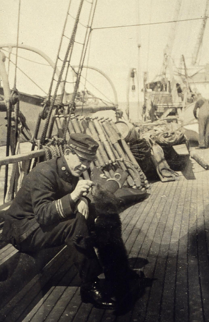 L.O. Colbert hand feeds Billy the bear on the deck of the USC&GSS Gedney.