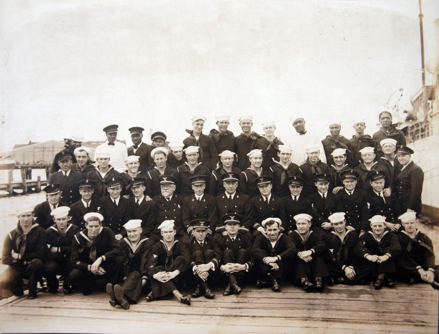 Black and white photo of the crew of the USC&GSS Lydonia on deck. There are four rows of crewmen.
