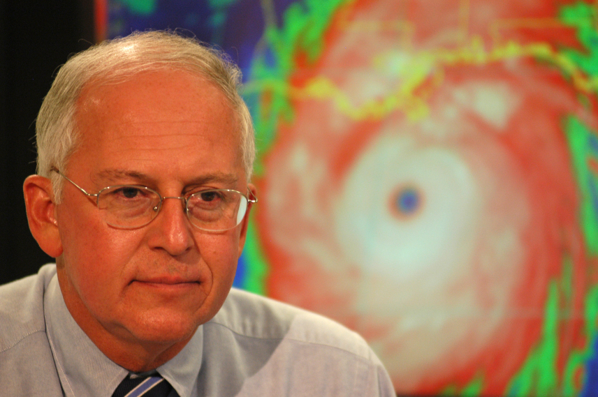 Close-up photo of Max Mayfield in front of a Hurricane Katrina graphic.
