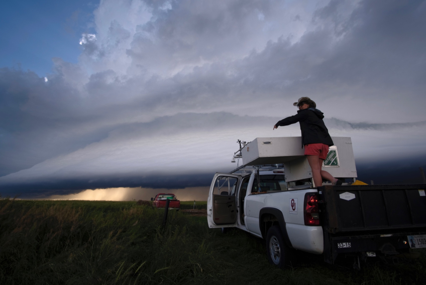 NOAA NSSL Researcher Elizabeth Smith preparing the LiDAR system for operation on the outskirts of a storm