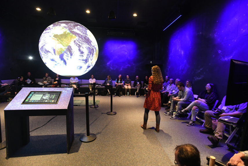 Presenter and audience sitting around a SOS globe.