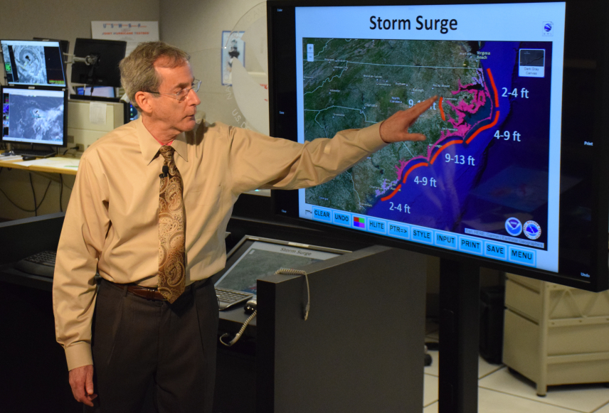 In a live television briefing, NHC Deputy Director Dr. Ed Rappaport emphasizes the expected life-threatening storm surge heights from Hurricane Florence. This message would be repeated continuously during Florence and Michael.