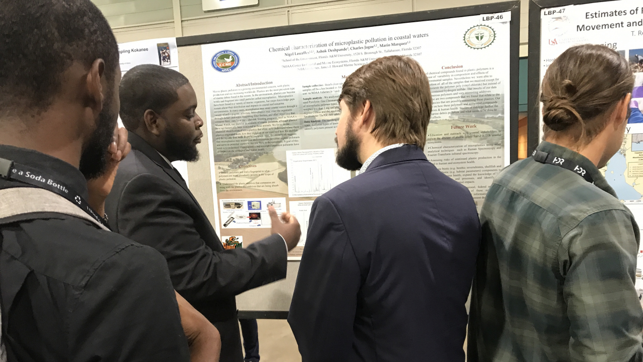 Nigel Lascelles, a graduate student supported by NOAA's Educational Partnership Program with Minority Serving Institutions (EPP/MSI) Cooperative Science Centers (CSCs), discusses his research with colleagues at the ASLO Aquatic Sciences Meeting in Puerto Rico in January 2019.