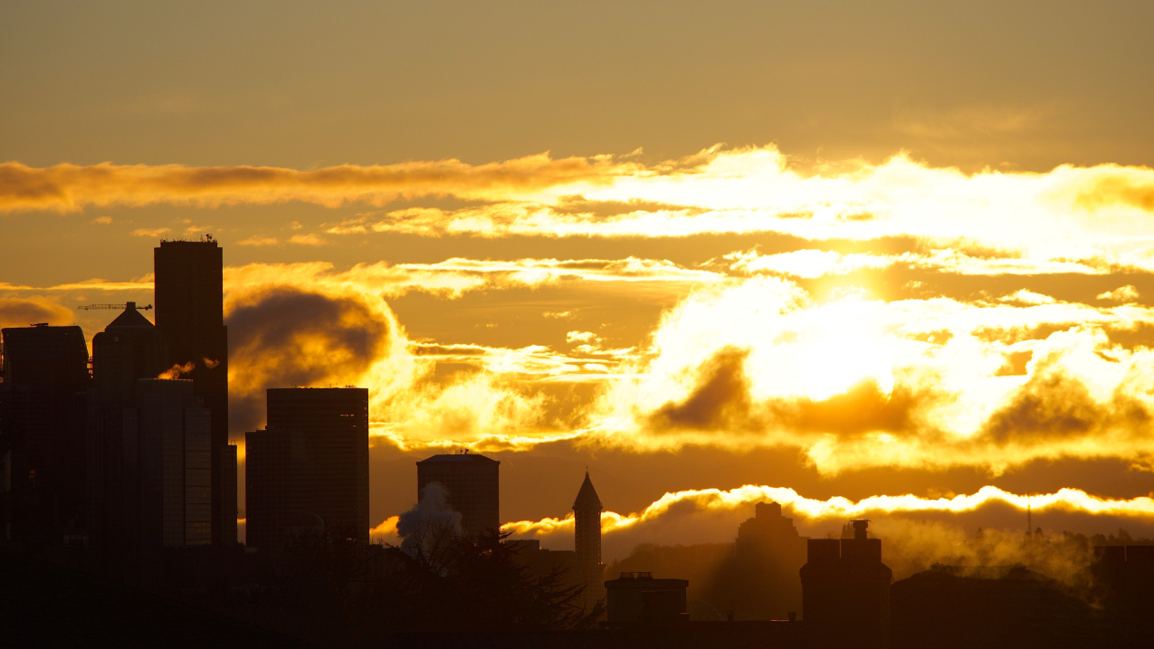 he sun rises over Seattle, Washington.