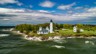 Photo showing an aerial view of historic Tibbetts Point Lighthouse in the Town of Cape Vincent in Jefferson County, New York. The lighthouse marks the point where Lake Ontario meets the St. Lawrence River and overlooks the eastern boundary of Lake Ontario National Marine Sanctuary. Credit: NOAA