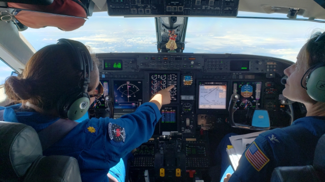 Lt. Cmdr. Rebecca Waddington and Capt. Kristie Twining aboard NOAA's Gulfstream IV-SP during a hurricane surveillance flight on August 5, 2018.