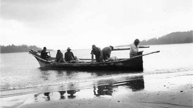Photo showing the Makah Tribe in a wooden canoe used to hunt whales at Neah Bay on the Olympic Peninsula in 1900. Photo courtesy Museum of History and Industry, Negative Number 88.33.122.
