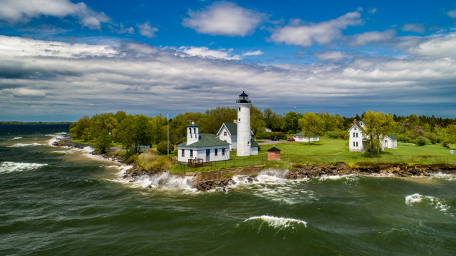 Photo showing an aerial view of historic Tibbetts Point Lighthouse in the Town of Cape Vincent in Jefferson County, New York. The lighthouse marks the point where Lake Ontario meets the St. Lawrence River and overlooks the eastern boundary of Lake Ontario National Marine Sanctuary. Credit: NOAA