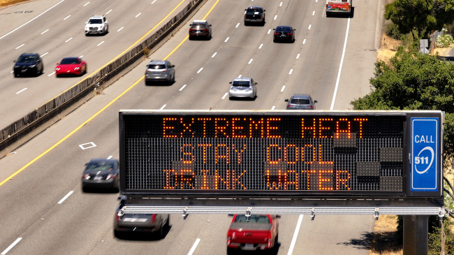 Photo showing an aerial view of  a Caltrans changeable message sign on Highway 101 that displays a warning about extreme heat on July 02, 2024 in Corte Madera, California. Much of California is experiencing an extended heat wave the will bring extreme temperatures to much of the state for the next week. (Photo by Justin Sullivan/Getty Images)