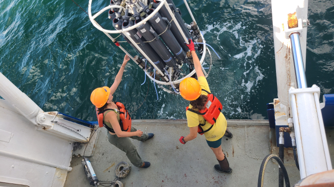 Photo showing Dr. Jill Tupitza and doctoral student Allison Noble collect near-bottom water aboard Research Vessel Pelican to obtain oxygen measurements used to determine the size of the Gulf of Mexico hypoxic zone. (LUMCON/LSU, Cassandra Glaspie)