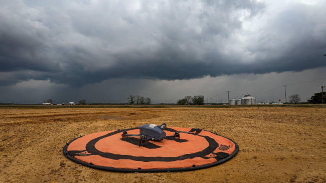 Photo showing a Coptersonde uncrewed aircraft, designed by the University of Oklahoma for weather-sensing, sitting in a field before flight operations. Credit: NOAA/NSSL/CIWRO/Tony Segales