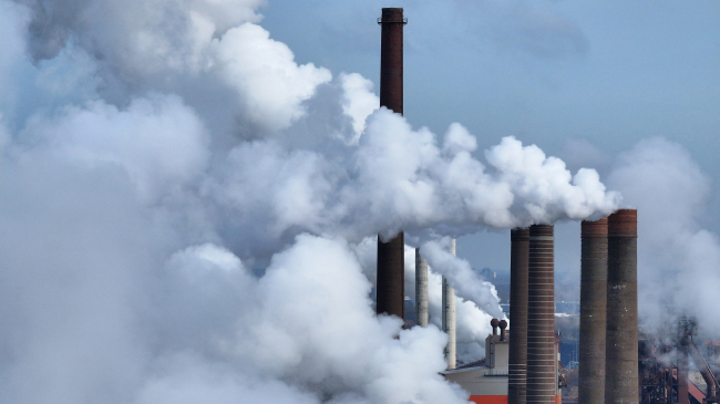 Water vapor and exhaust rise from the steel mill of Salzgitter AG, one of Europe's largest steel producers in Salzgitter, Germany. The company is investing heavily towards CO2-free steel production. Credit: Getty Images.