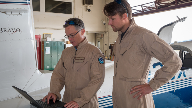 Stefan Schwietzke (right) and pilot Stephen Conley prepare for a 2014 research flight in Colorado.