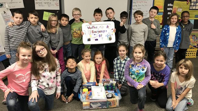 Instead of creating a traditional gift basket for their annual holiday auction, these second-graders decided to prepare a weather-ready kit.