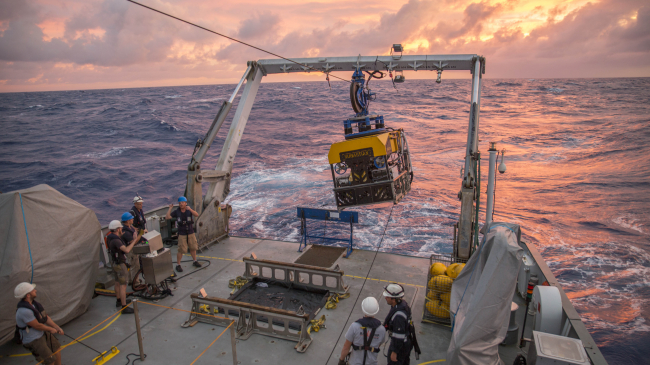 The remotely operated vehicle SuBastian aboard Schmidt Ocean Institute's research vessel Falkor at sunset in the Marianas Trench Marine Protected Area. (2016 photo)