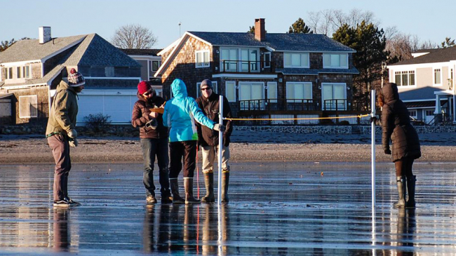 Volunteers measuring the slope of New Hampshire's Jenness Beach. 
