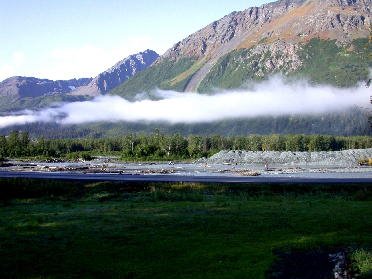 A ribbon of cloud separates mountain and valley