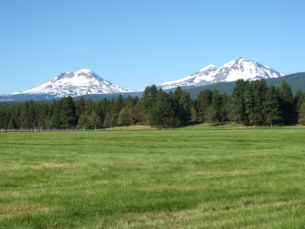 The Three Sisters with South Sister Peak on the left as seen from west ofSisters on Oregon Highway 242