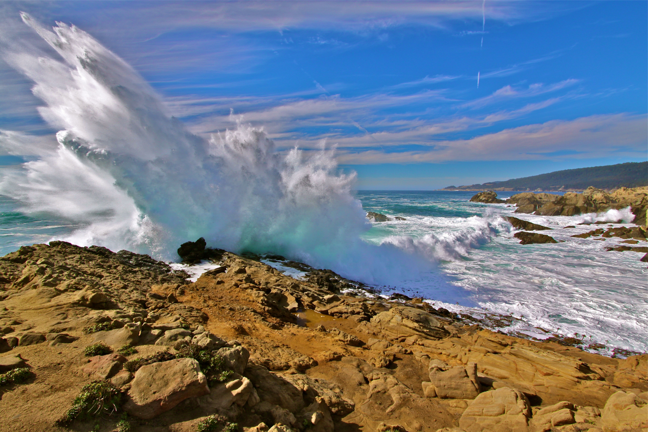 Waves pound the California coast sending spray skyward