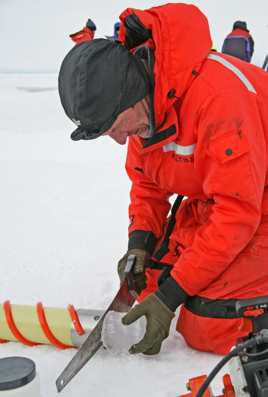 Sawing through ice core to obtain samples for analysis