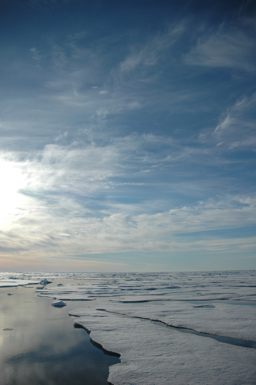 Midnight sun, melting Arctic ice, open leads, and cirrus clouds
