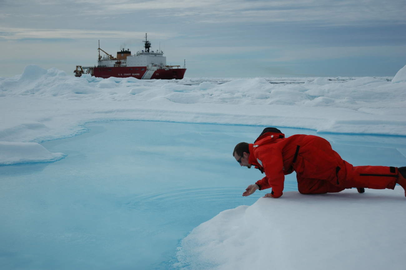 Scientist testing the waters so to speak with the USCG Icebreaker HEALY in thebackground