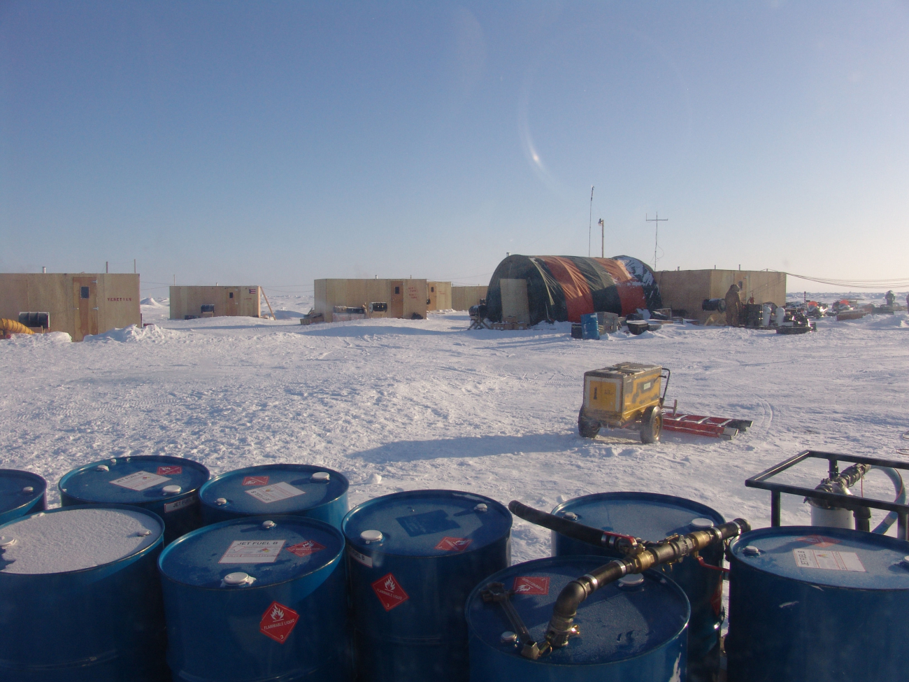 Fuel oil drums and living and working spaces at ice camp