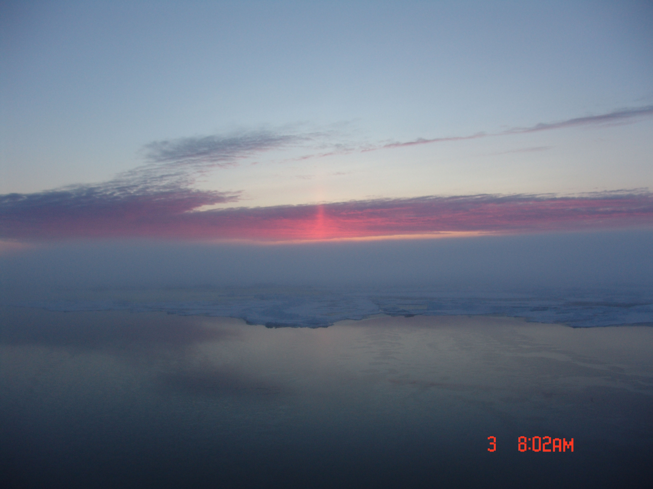 A sun pillar seen above the pack ice fringing a polynya