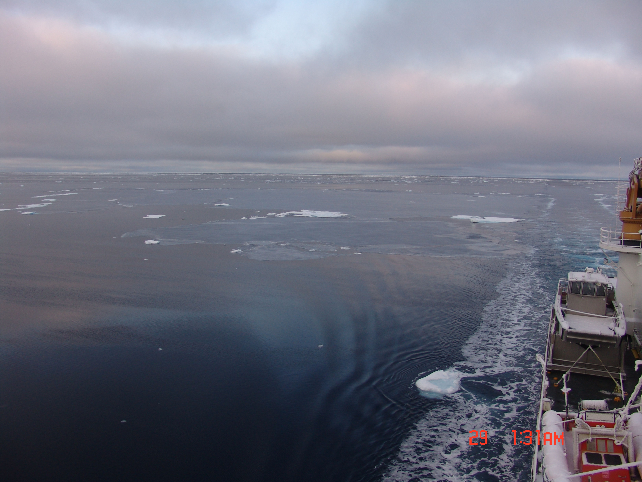 The CGC HEALY proceeding through grease ice with some small floes in thearea