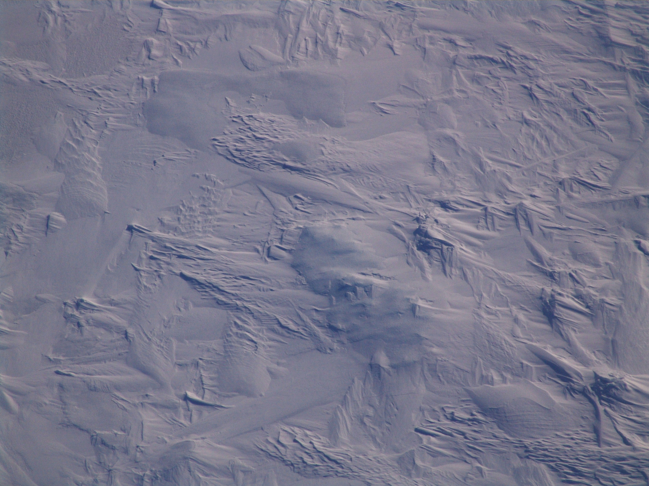 Multi-year ice with patterns caused by collisions, freezing and refreezing, andwind patterns caused by ablation and wind-sculpted snow