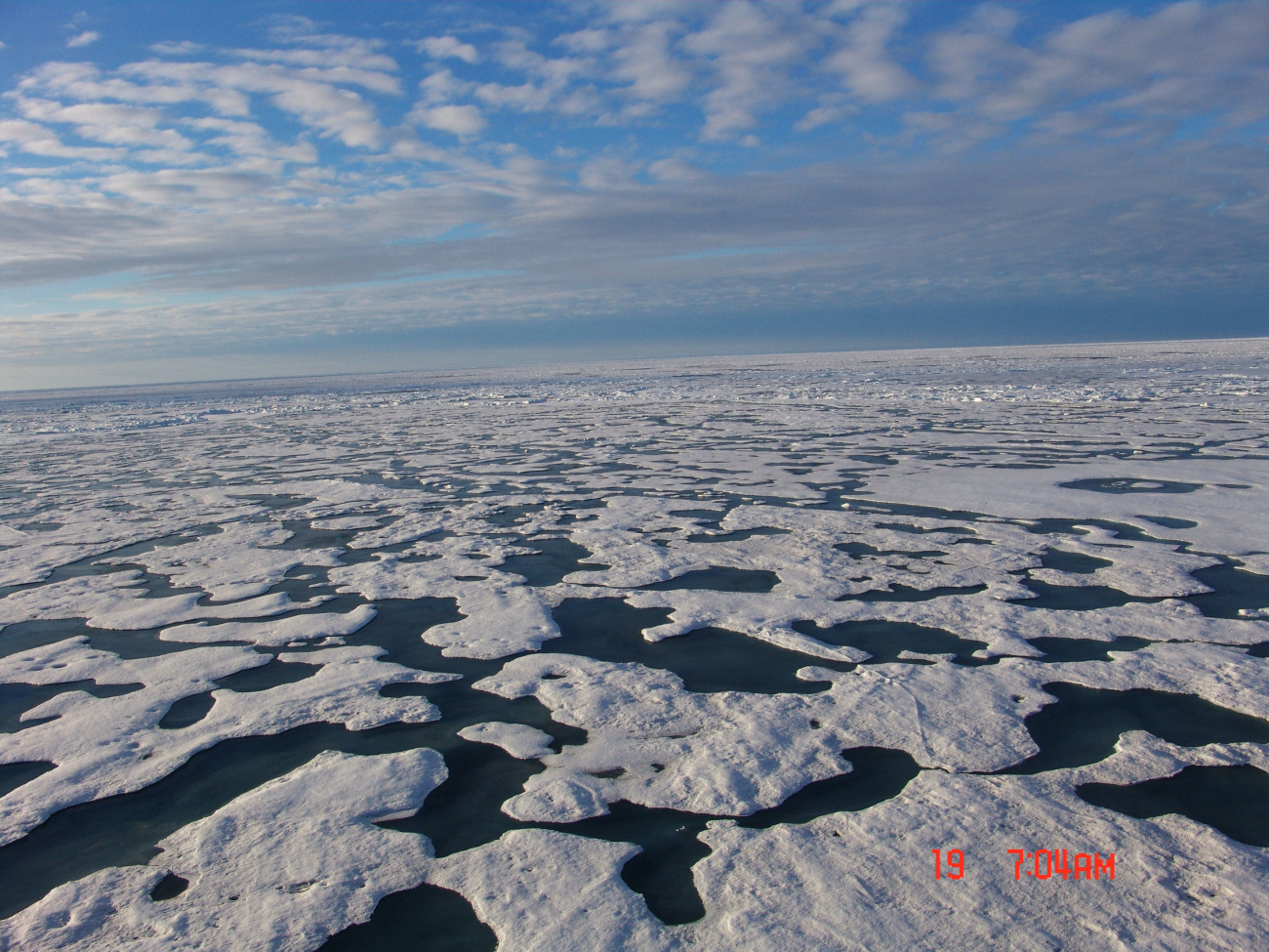 2nd year to multi-year hummocky ice with melt pond and ridges seeminglyconverging towards horizon