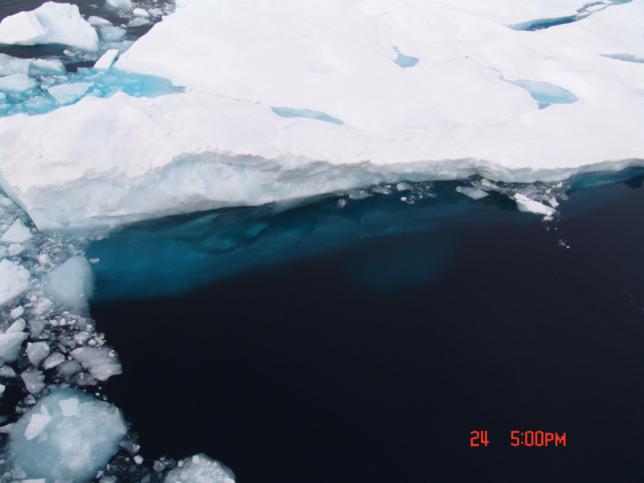 A large aquamarine keel is apparent on the edge of a multi-year ice floe