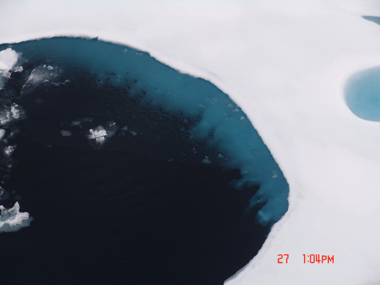 A large melt pool that has been completely melted looking down into theunderlying ocean water