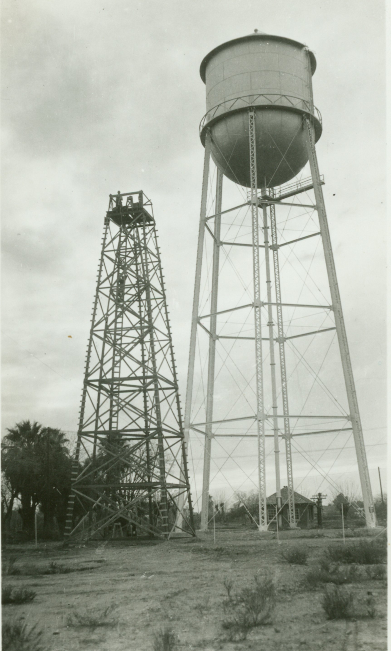 A large wooden tower on an Arizona Station next to a water tank
